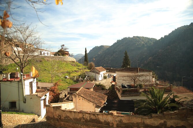 Granada Highlights Tour with Tapas Breaks by Electric Bike - City center square and a riverbank street worth savoring