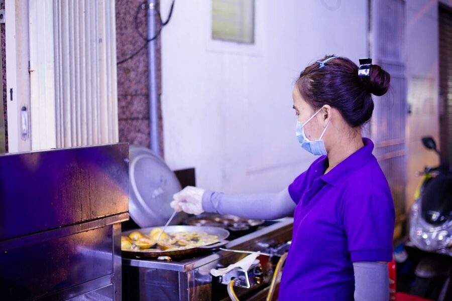 Ho Chi Minh City: Private Street Food Motorbike Tour - Old apartments, a pagoda tucked inside, and the night flower market