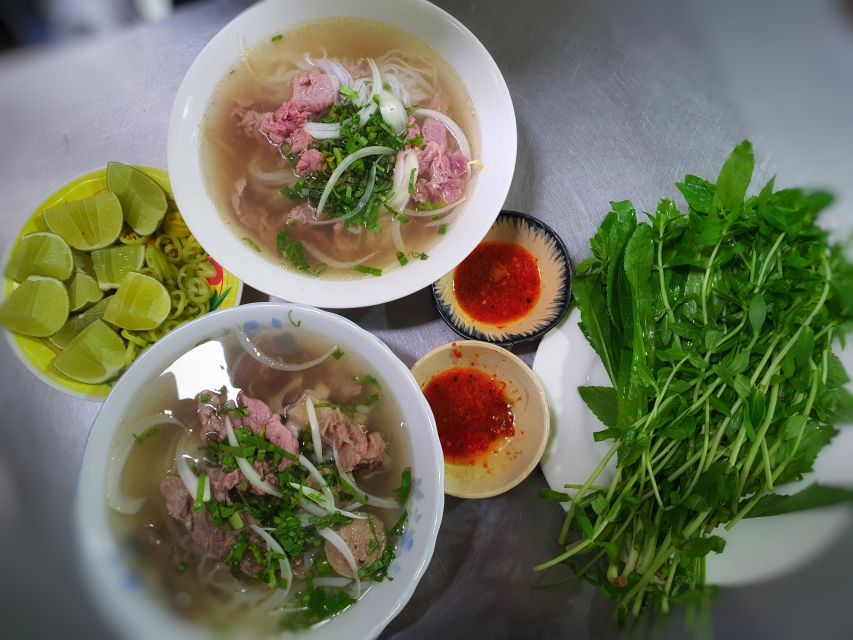 Ho Chi Minh City: Street Food and Sightseeing by Motorbike - District 5 Chinatown markets: motorbike stalls, lanterns, and medicine