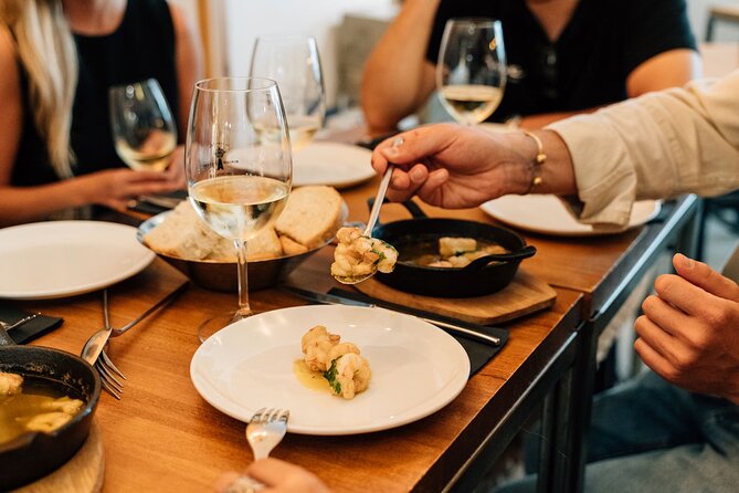 Madrid Tapas & Wine Tour with Rooftop Views and Local Guide - Calle de las Huertas: carrilleras, smashed potatoes, and a solid red