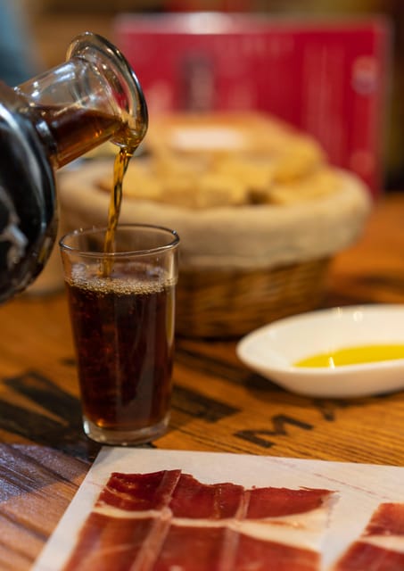 Málaga: Wine & Tapas Tour - Iberian ham at a family-run shop, then sausage-cheese-vermouth bites
