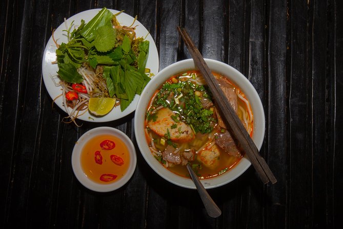 Saigon Night Street Food and City Tour on Scooter - Noodle soup stop: comfort food that also teaches you Vietnamese eating culture
